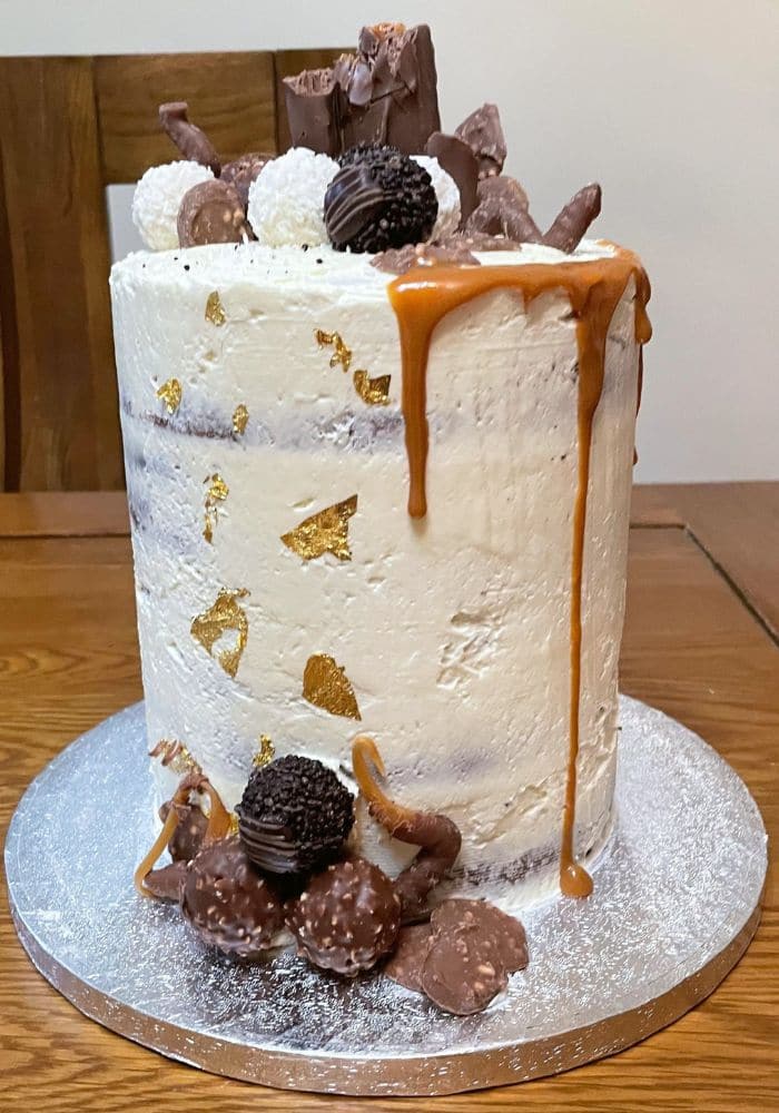 Buttercream cake with gold leaf, caramel drip and chocolate truffles