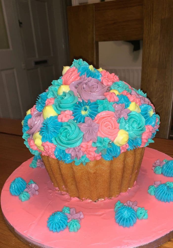 Giant cupcake cake covered in pastel piped flowers