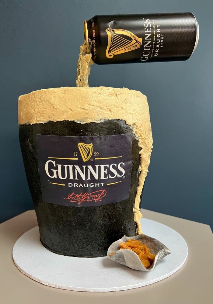 Novelty cake shaped like a pint of Guinness with a cream head