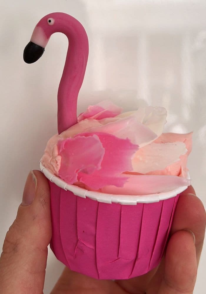 Bright pink cupcake decorated with a sugar flamingo