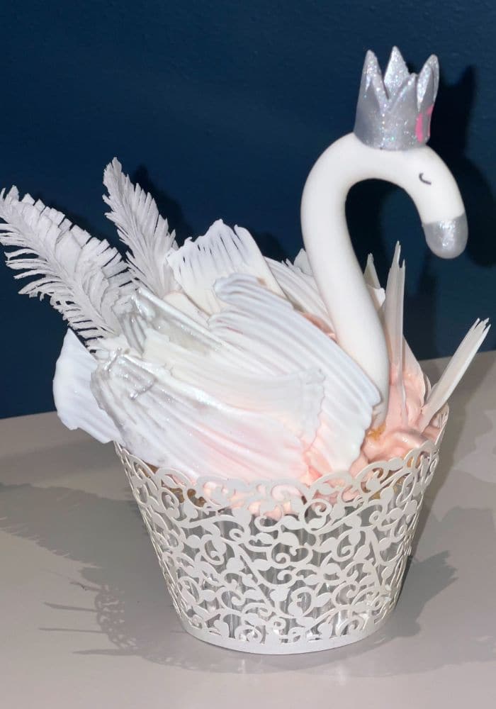 Cupcake piped as a white swan with feathered wings
